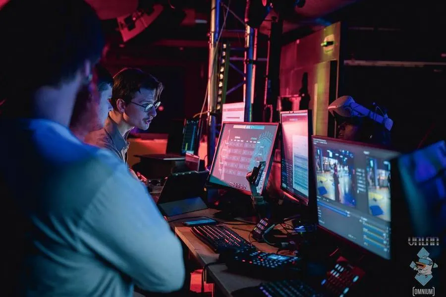 The VRLAN 2024 broadcast production desk, with operators at a vision mixer surrounded by monitors.