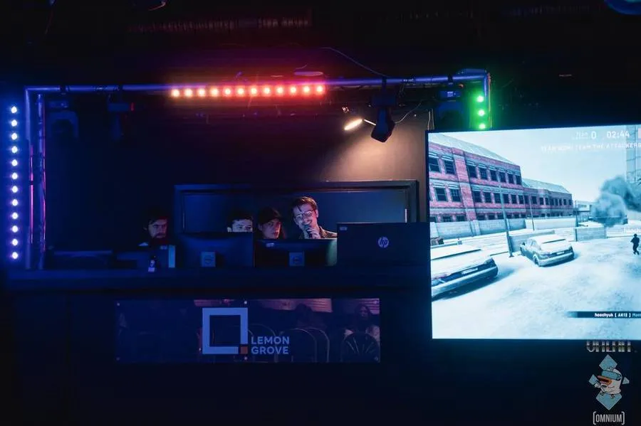 The caster booth beside a big gameplay screen at The Lemon Grove.