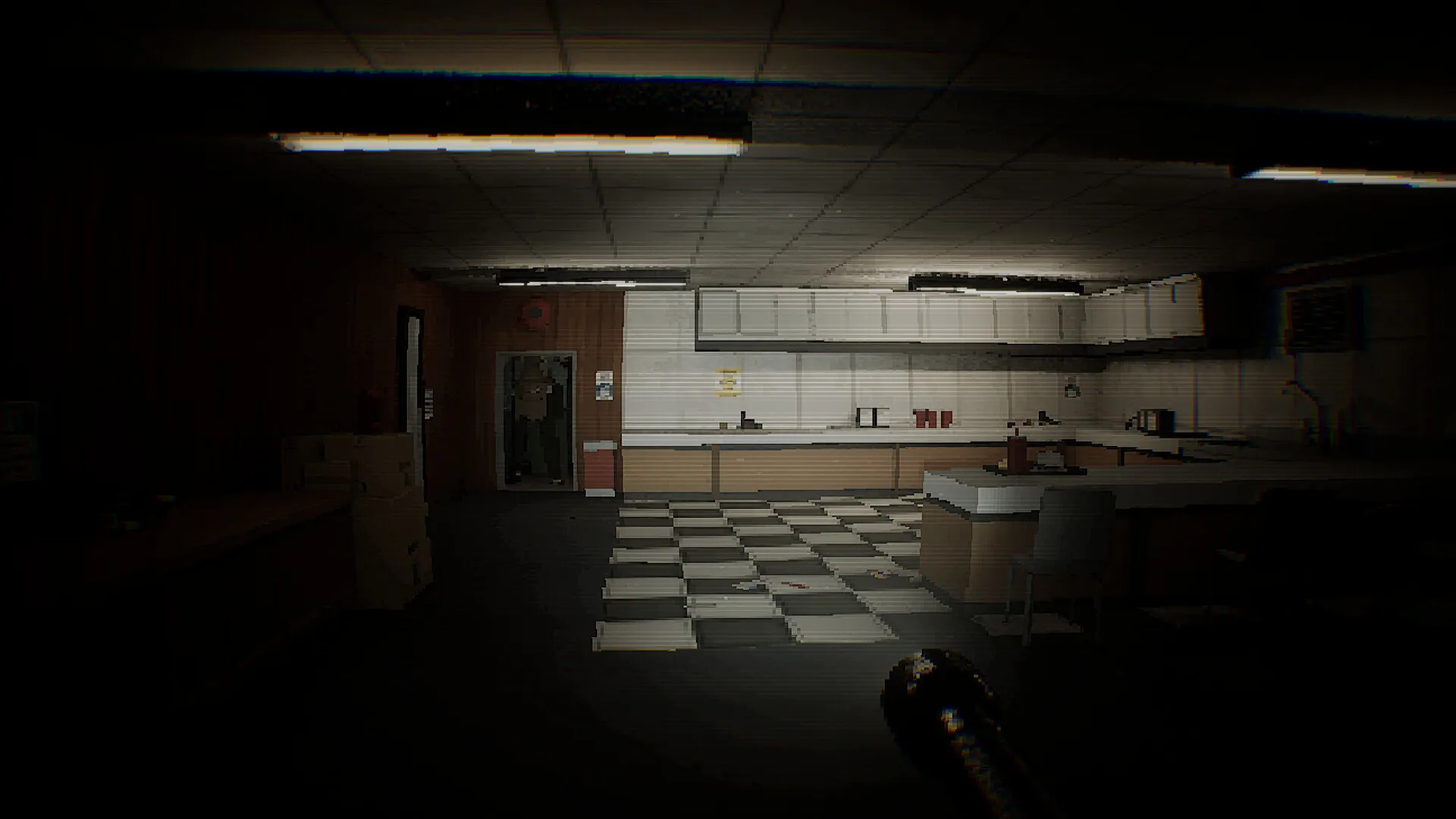 A checkered-floor staff room lit by a single strip light.