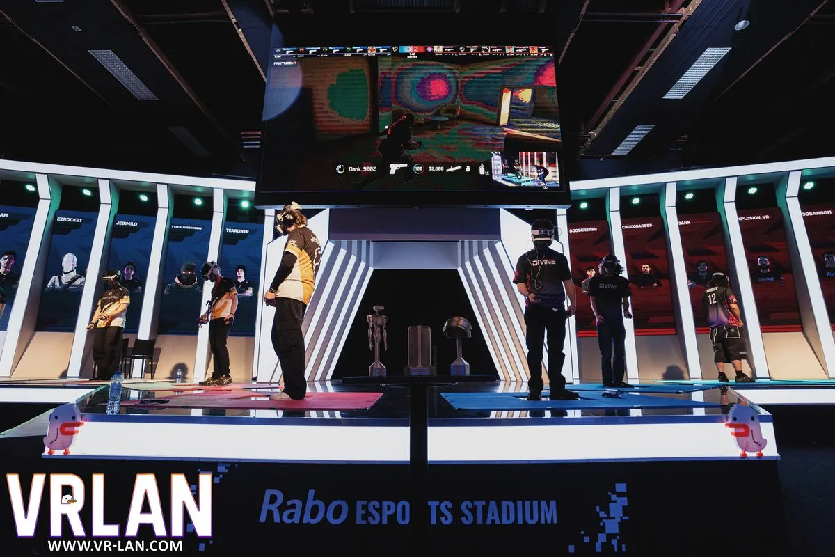 A wide shot of the VRLAN 2026 stage beneath the big screen.