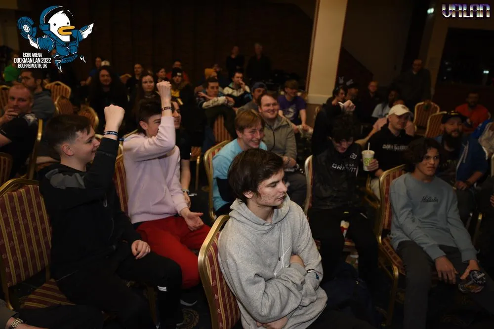 A seated crowd cheering during a match at Duckman LAN 2022.